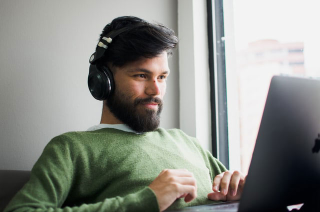 a young man listening to Be elearning